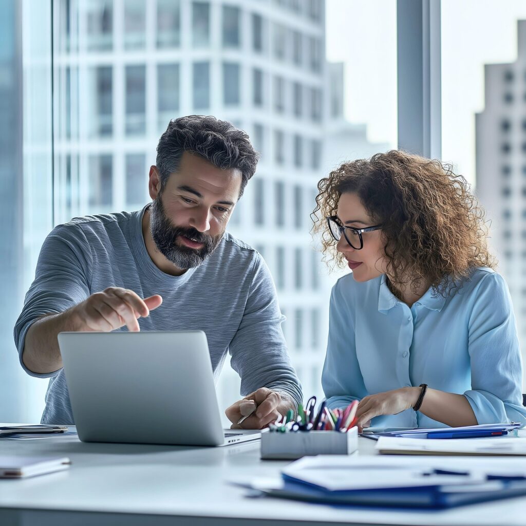 Business team collaborating on laptop